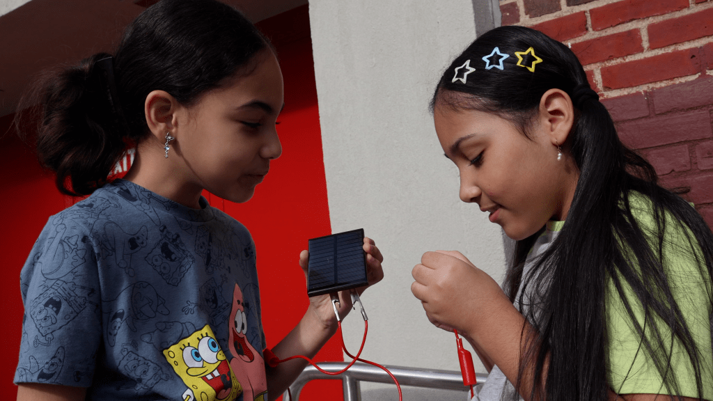 students working on solar panel